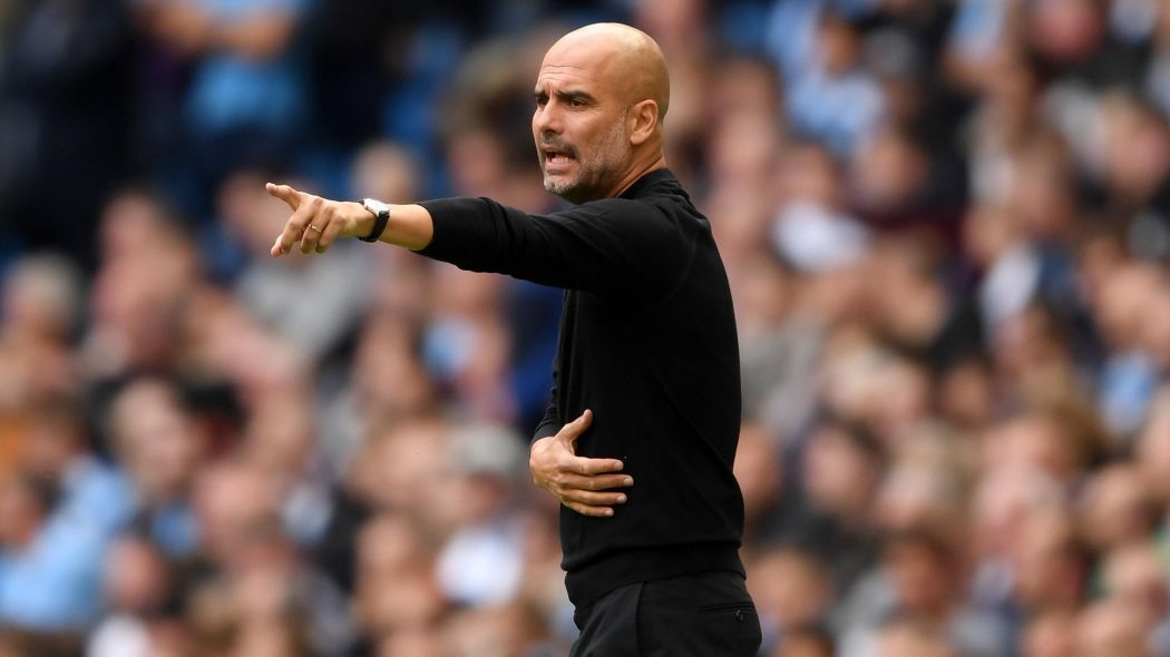 Pep Guardiola instructing his Man City players from the sideline