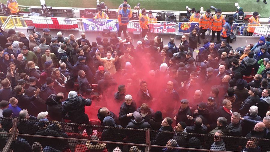 Liverpool fans throw flare at Chelsea fans in the away end